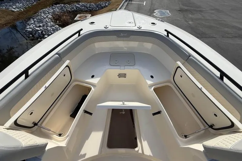  Yacht Photos Pics 2026 Scout 277 LXF boat interior with open storage compartments and seating.