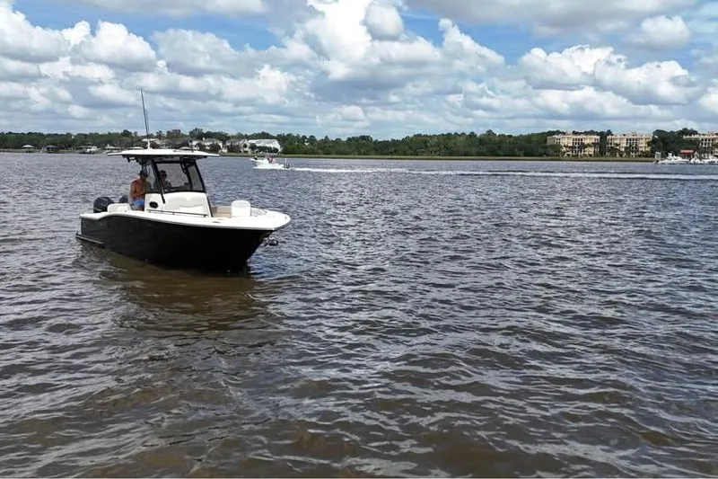  Yacht Photos Pics 2026 Scout 277 LXF boat on a calm river under a cloudy sky.