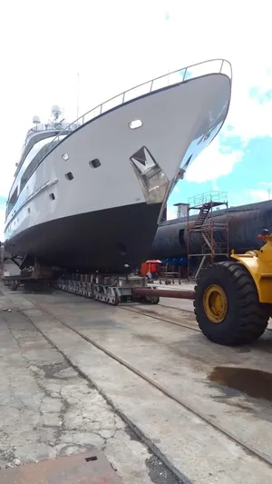 Ligaya Yacht Photos Pics Large yacht "Ocean Pacifico Diana" 2002 on dry dock with industrial equipment nearby.