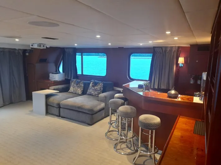 Ligaya Yacht Photos Pics Luxurious yacht interior with plush seating, bar stools, and ocean view windows, Ocean Pacifico Diana 2002.