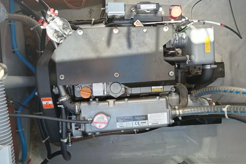  Yacht Photos Pics Engine compartment of a 2019 Lagoon 42 catamaran, showcasing mechanical components and wiring.