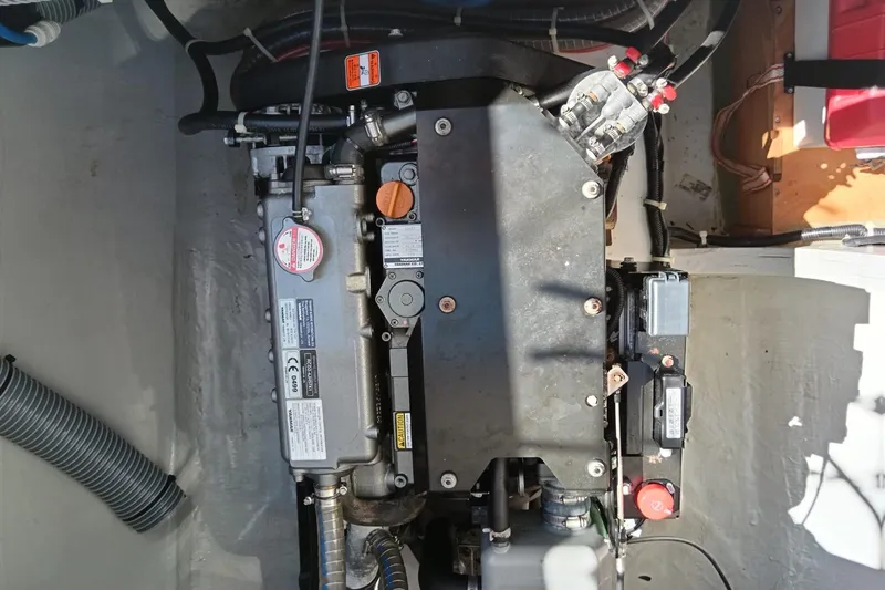  Yacht Photos Pics Engine compartment of a 2019 Lagoon 42 catamaran, showcasing mechanical components and wiring.