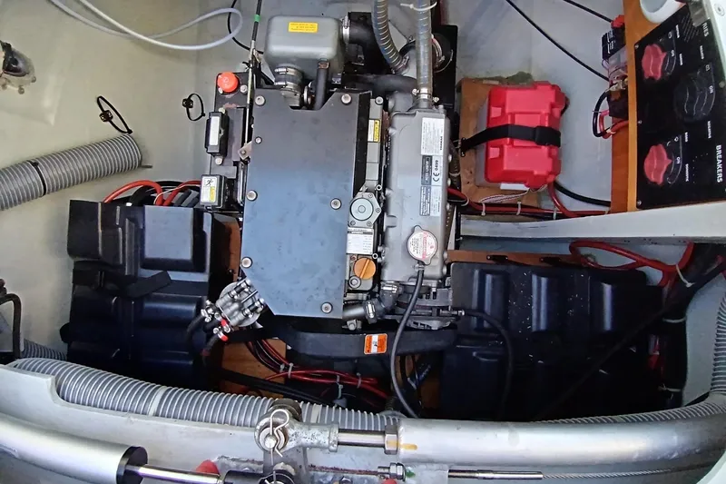  Yacht Photos Pics Engine compartment of a 2019 Lagoon 42 catamaran, showcasing mechanical components and wiring.