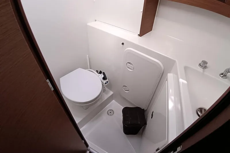  Yacht Photos Pics 2019 Lagoon 42 yacht bathroom with toilet, sink, and storage compartment.