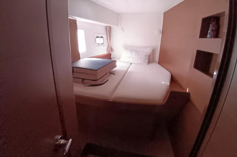  Yacht Photos Pics Cozy cabin interior of 2019 Lagoon 42 catamaran with bed and window view.