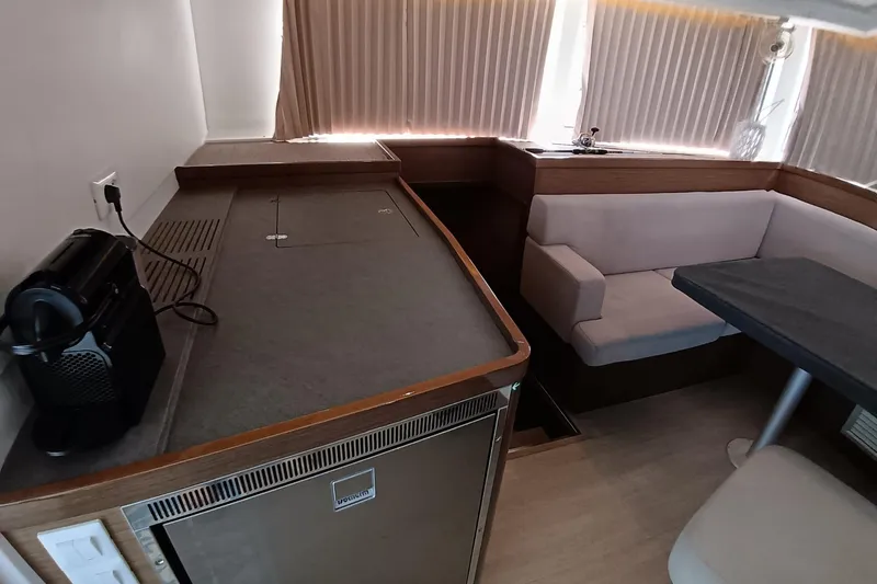  Yacht Photos Pics Interior of 2019 Lagoon 42 yacht with kitchenette and seating area.
