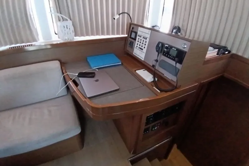  Yacht Photos Pics Interior of 2019 Lagoon 42 yacht with navigation station and seating area.