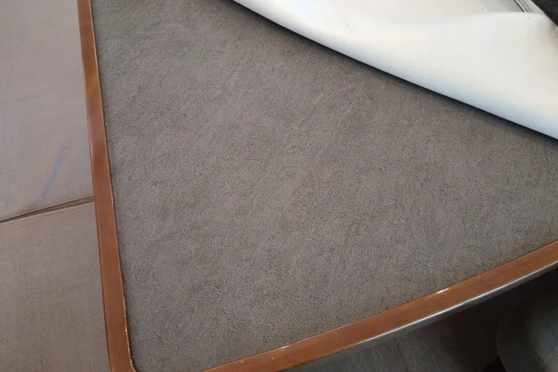  Yacht Photos Pics Interior detail of a 2019 Lagoon 42, featuring a wooden-edged table with a gray surface.