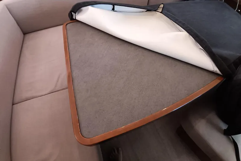  Yacht Photos Pics Interior of 2019 Lagoon 42 yacht showing a cushioned seating area and table.