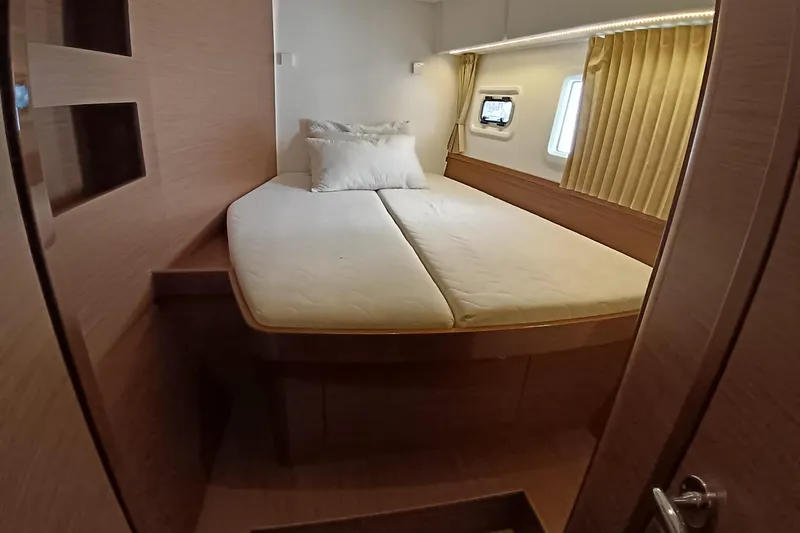  Yacht Photos Pics Cozy bedroom interior of 2019 Lagoon 42 yacht with double bed and window.