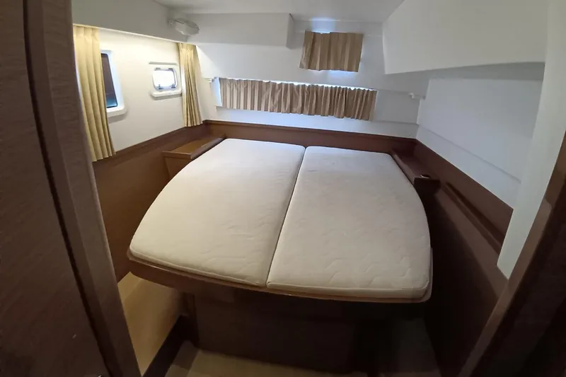  Yacht Photos Pics Interior cabin of 2019 Lagoon 42 catamaran with double bed and windows.