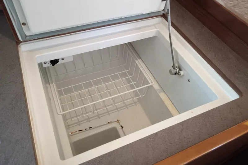  Yacht Photos Pics Open storage compartment on 2019 Lagoon 42 yacht, featuring a wire basket and secure latch.