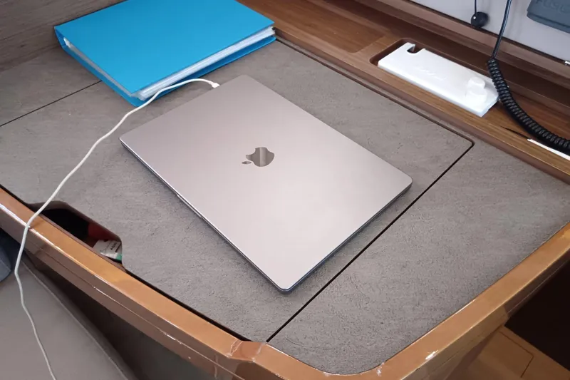  Yacht Photos Pics Laptop and blue folder on a Lagoon 42 yacht's wooden desk, 2019 model.