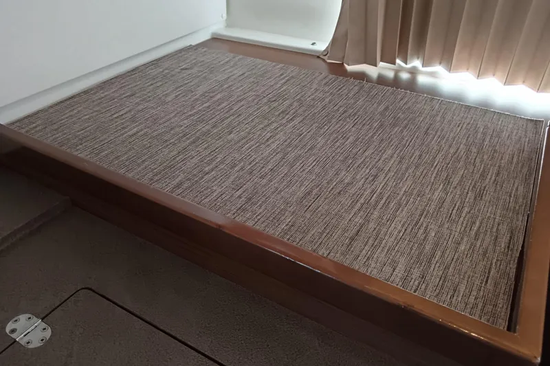  Yacht Photos Pics Interior of 2019 Lagoon 42 yacht featuring a wooden platform with textured mat.