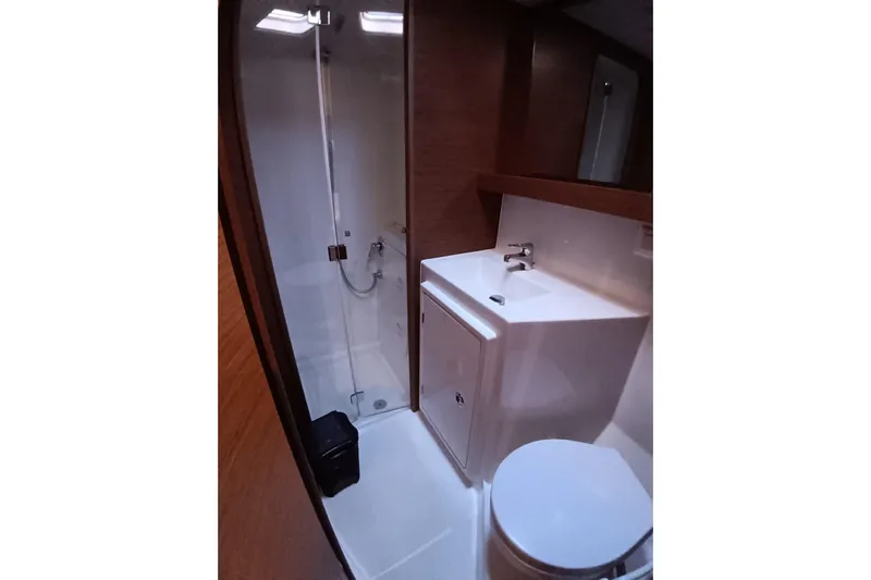  Yacht Photos Pics Bathroom interior of 2019 Lagoon 42 yacht with shower, sink, and toilet.