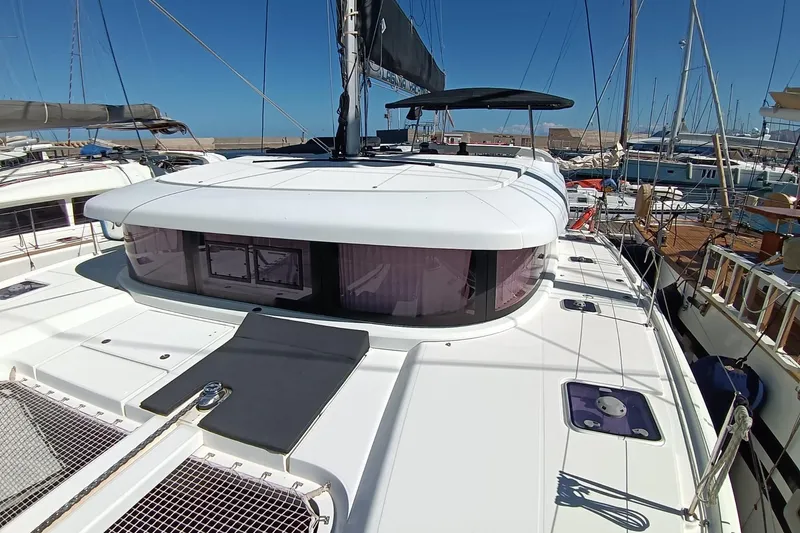  Yacht Photos Pics 2019 Lagoon 42 catamaran docked at marina under clear blue sky.