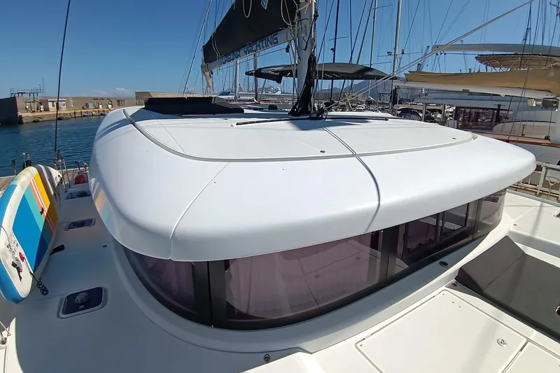  Yacht Photos Pics 2019 Lagoon 42 catamaran docked at marina, featuring sleek design and spacious deck.