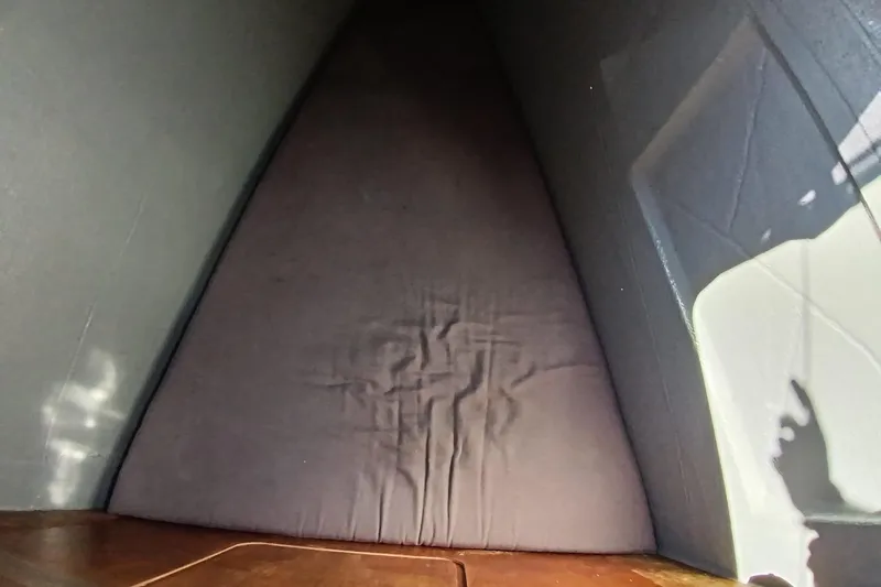  Yacht Photos Pics Interior cabin view of a 2019 Lagoon 42 catamaran, featuring a triangular bed.