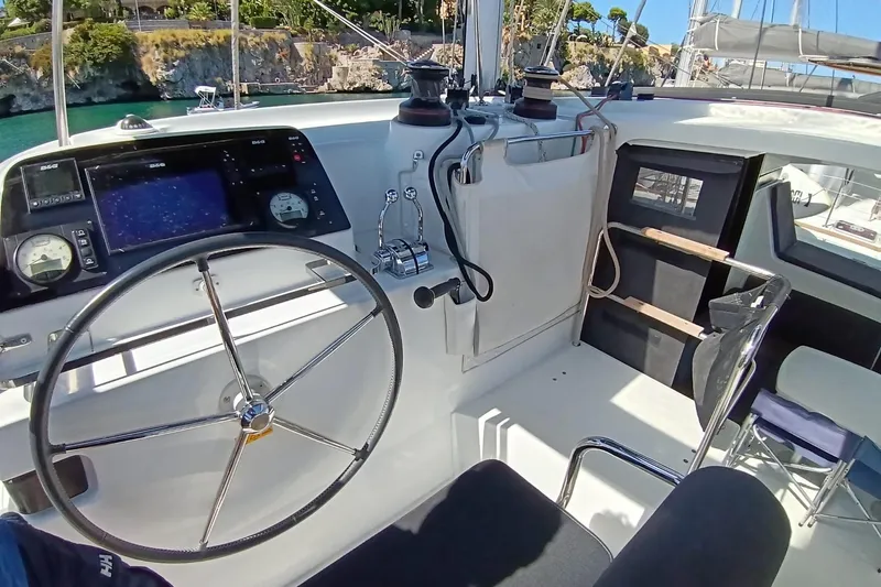  Yacht Photos Pics Cockpit of 2019 Lagoon 42 catamaran with steering wheel and navigation instruments.