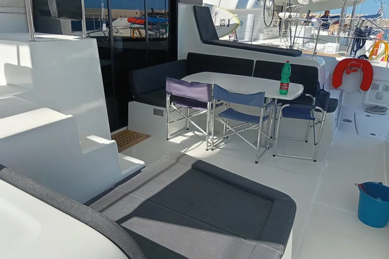  Yacht Photos Pics Spacious deck of 2019 Lagoon 42 catamaran with seating and dining area.