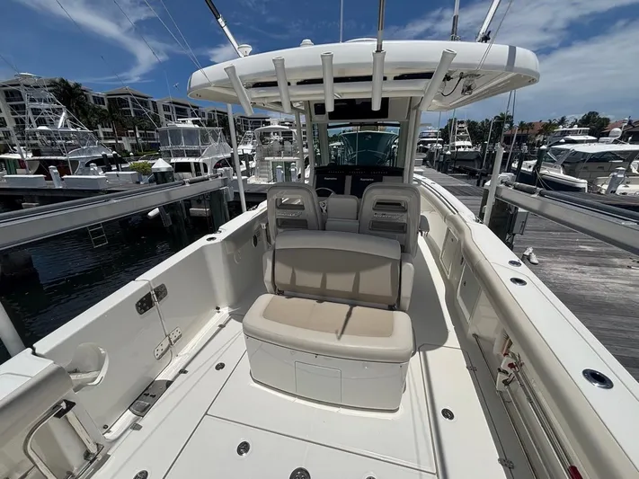  Yacht Photos Pics 2019 Boston Whaler 330 Outrage boat interior at marina, featuring seating and helm station.