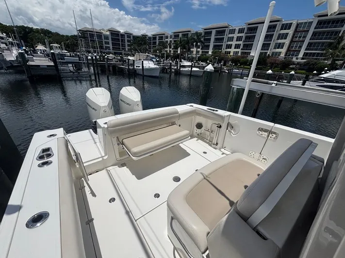  Yacht Photos Pics 2019 Boston Whaler 330 Outrage boat docked at marina with twin Mercury engines.