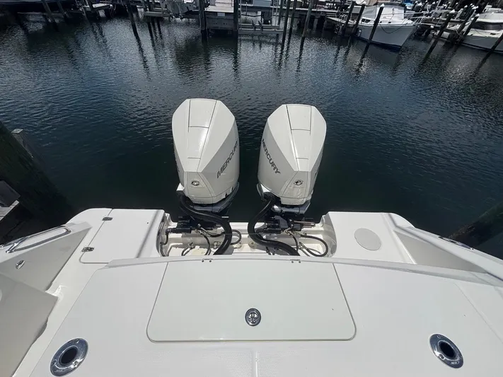  Yacht Photos Pics 2019 Boston Whaler 330 Outrage with twin Mercury outboard engines at a marina.