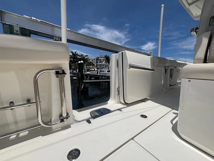  Yacht Photos Pics 2019 Boston Whaler 330 Outrage boat interior with open door, dockside view.