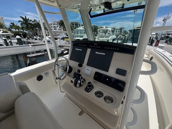  Yacht Photos Pics 2019 Boston Whaler 330 Outrage helm with Raymarine electronics at marina.