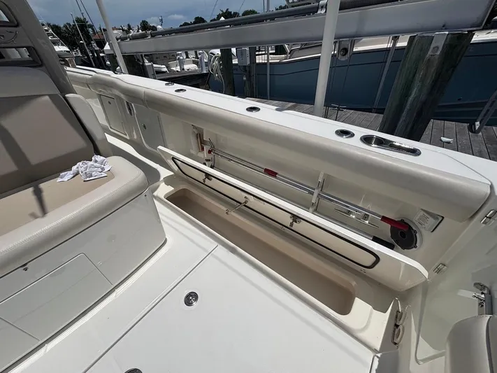 Yacht Photos Pics 2019 Boston Whaler 330 Outrage boat interior with open storage compartment.