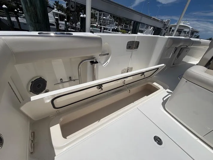  Yacht Photos Pics 2019 Boston Whaler 330 Outrage boat interior with open storage compartment.