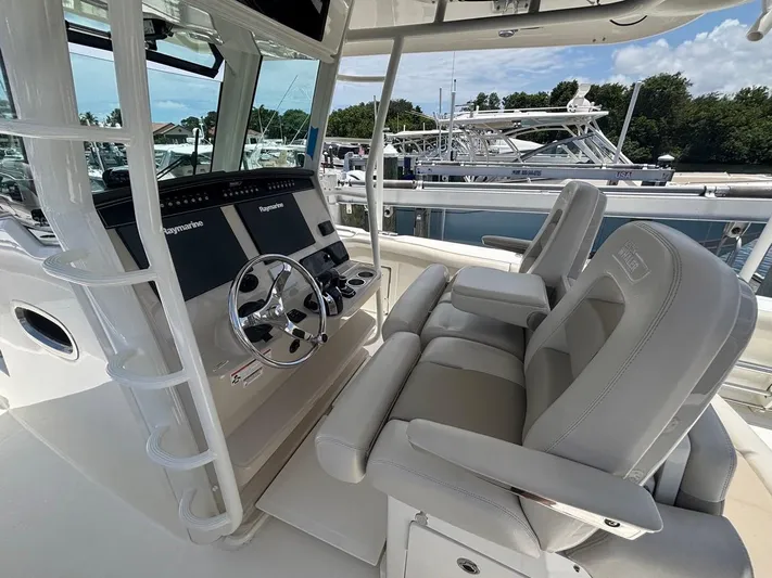  Yacht Photos Pics 2019 Boston Whaler 330 Outrage helm with dual Raymarine displays and comfortable seating.
