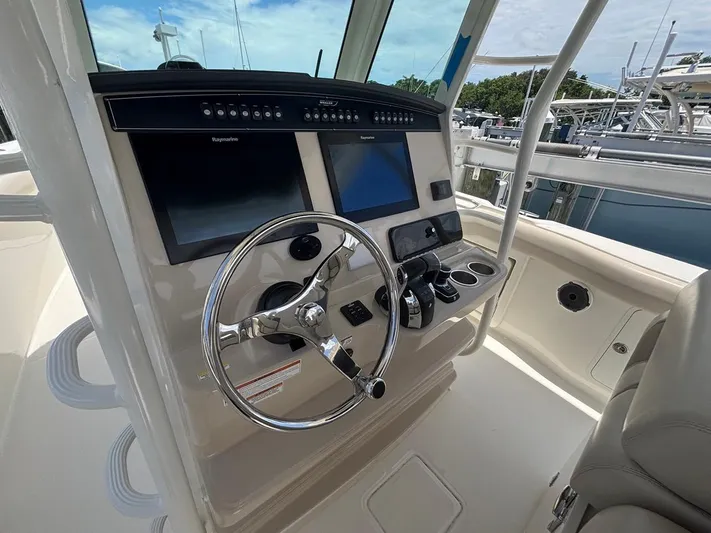  Yacht Photos Pics 2019 Boston Whaler 330 Outrage helm with dual Raymarine displays and stainless steel steering wheel.