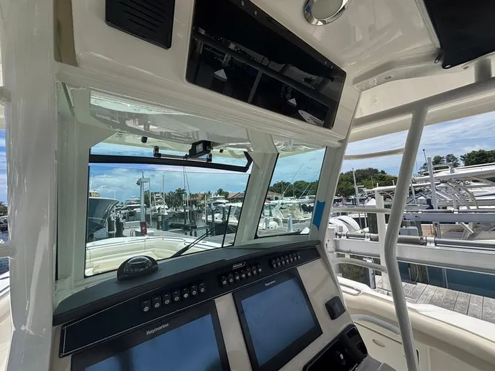  Yacht Photos Pics 2019 Boston Whaler 330 Outrage helm with navigation screens at marina.