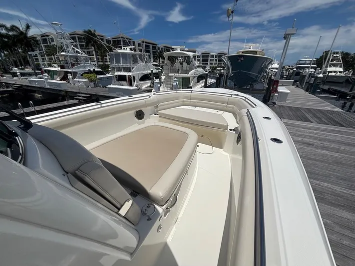  Yacht Photos Pics 2019 Boston Whaler 330 Outrage docked, showcasing spacious seating and sleek design.