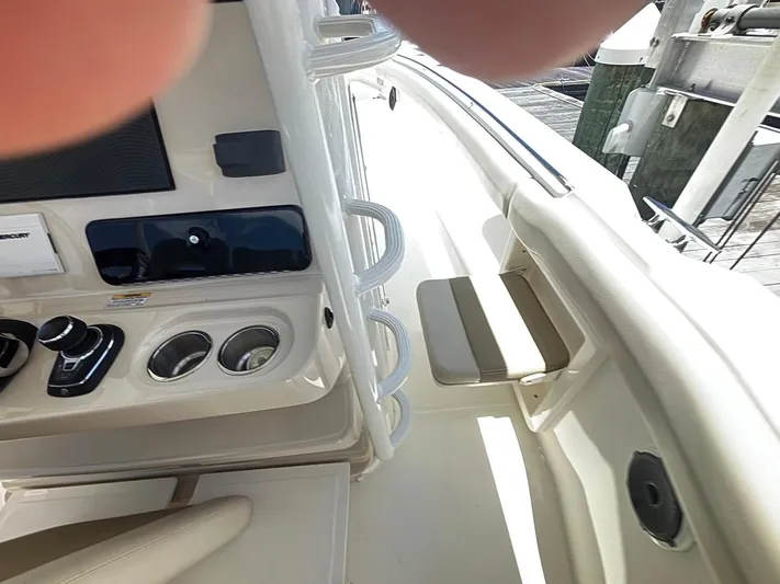  Yacht Photos Pics 2019 Boston Whaler 330 Outrage boat interior with control panel and seating.