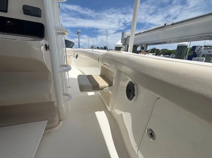  Yacht Photos Pics 2019 Boston Whaler 330 Outrage interior with seating and speaker, under clear sky.