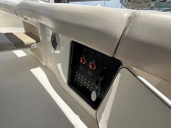  Yacht Photos Pics 2019 Boston Whaler 330 Outrage interior with control panel and seating.