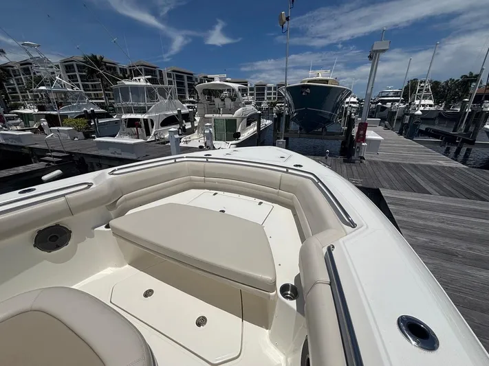  Yacht Photos Pics 2019 Boston Whaler 330 Outrage docked, showcasing spacious seating and sleek design.