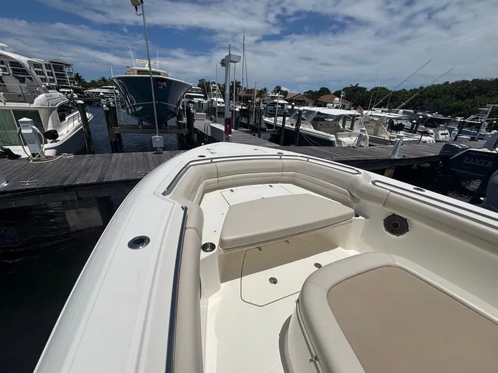  Yacht Photos Pics 2019 Boston Whaler 330 Outrage docked at marina under blue sky.