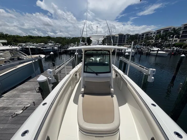  Yacht Photos Pics 2019 Boston Whaler 330 Outrage docked at marina under cloudy sky.