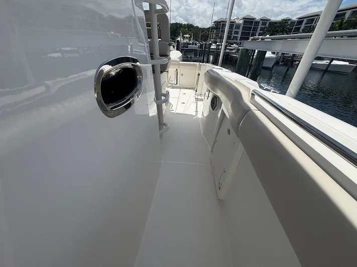  Yacht Photos Pics 2019 Boston Whaler 330 Outrage boat deck, featuring sleek design and marina view.