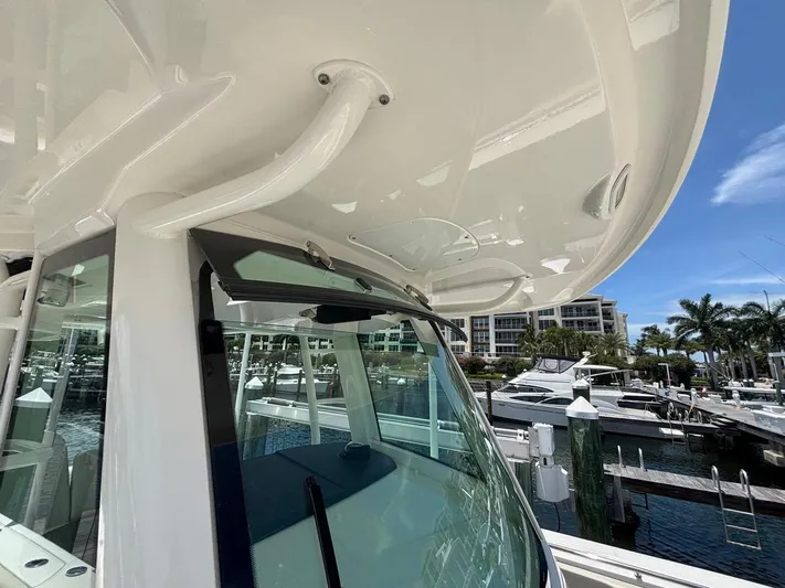  Yacht Photos Pics 2019 Boston Whaler 330 Outrage boat docked at marina, showcasing sleek design and windshield.