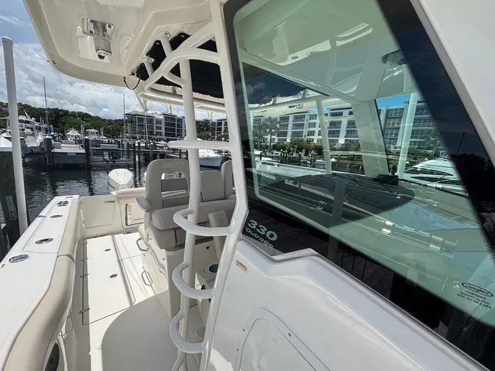  Yacht Photos Pics 2019 Boston Whaler 330 Outrage boat docked at marina, showcasing sleek design and spacious deck.
