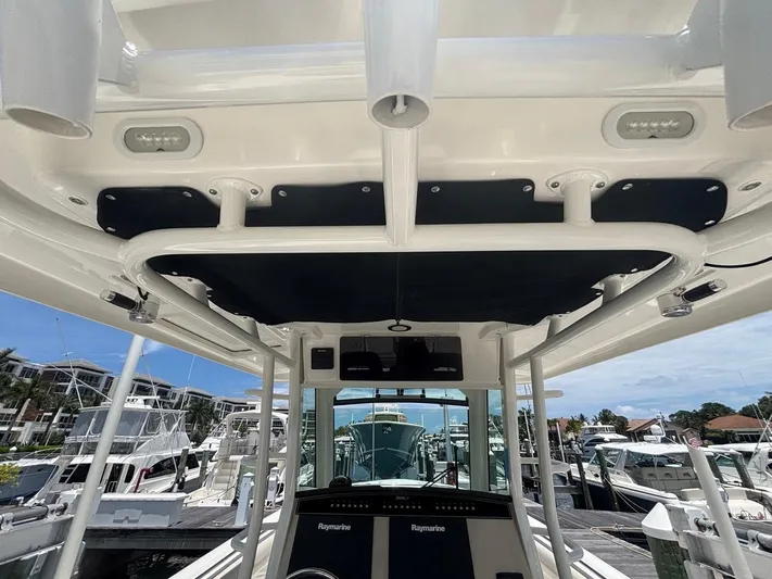  Yacht Photos Pics 2019 Boston Whaler 330 Outrage boat interior with advanced navigation equipment at a marina.