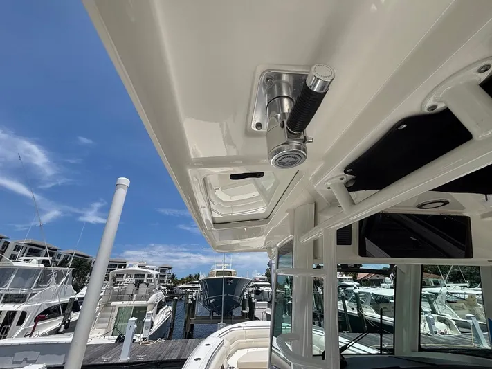  Yacht Photos Pics 2019 Boston Whaler 330 Outrage boat docked, showcasing sleek design and marina background.