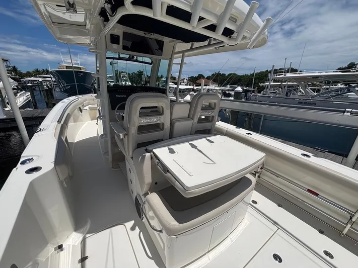  Yacht Photos Pics 2019 Boston Whaler 330 Outrage boat interior with seating and helm, docked at marina.