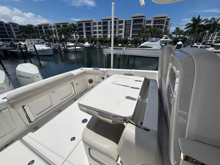  Yacht Photos Pics 2019 Boston Whaler 330 Outrage at marina, featuring spacious deck and seating area.
