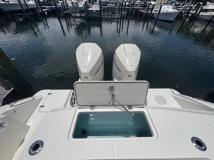  Yacht Photos Pics 2019 Boston Whaler 330 Outrage with dual Mercury engines at a marina dock.