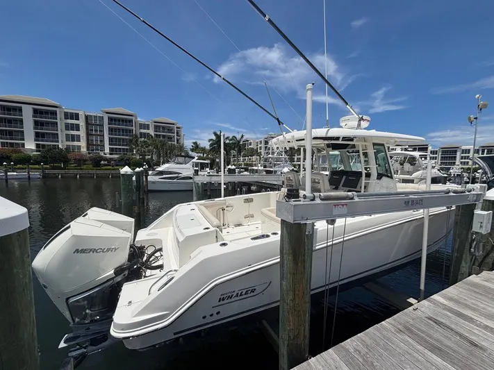  Yacht Photos Pics 2019 Boston Whaler 330 Outrage docked at marina with Mercury engines.